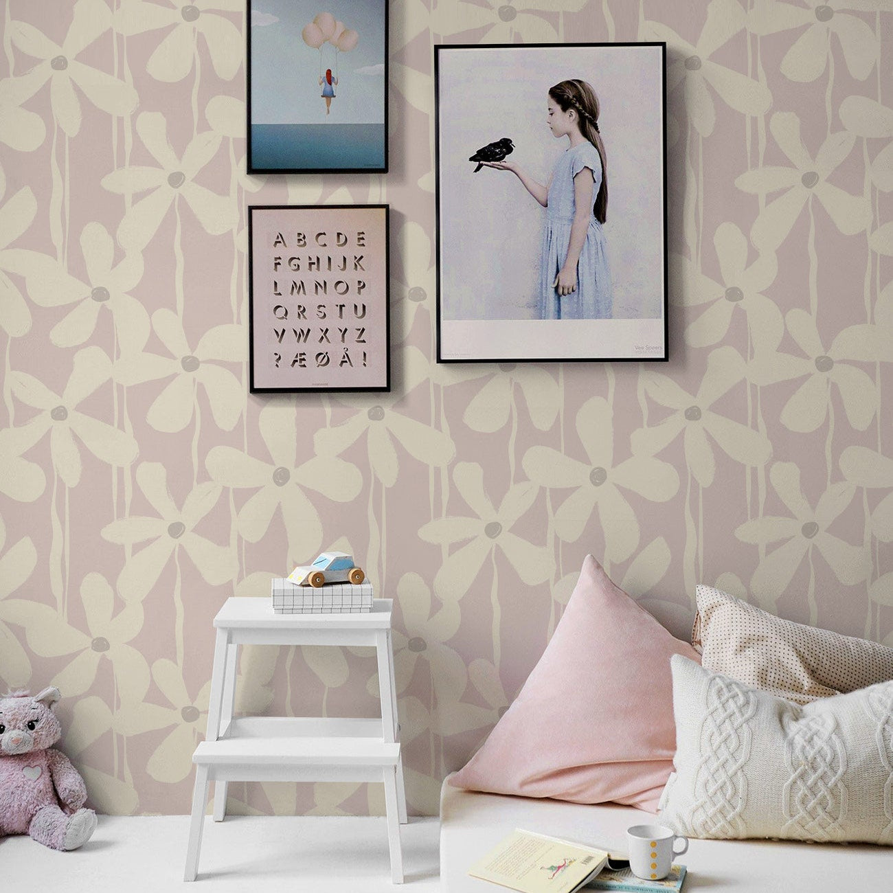 A graphic brushstroke floral wallpaper in a soft pink nursery room adds a calming feminine touch.