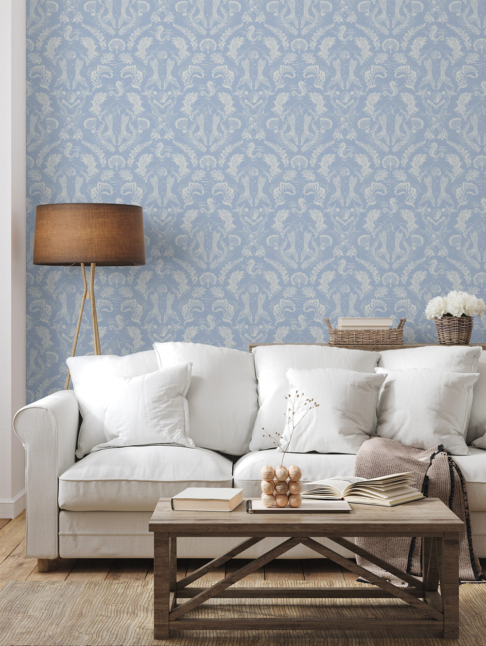 A stunning Dreamy Mermaid wallpaper in a soft blue color palette in a beautiful coastal living room.