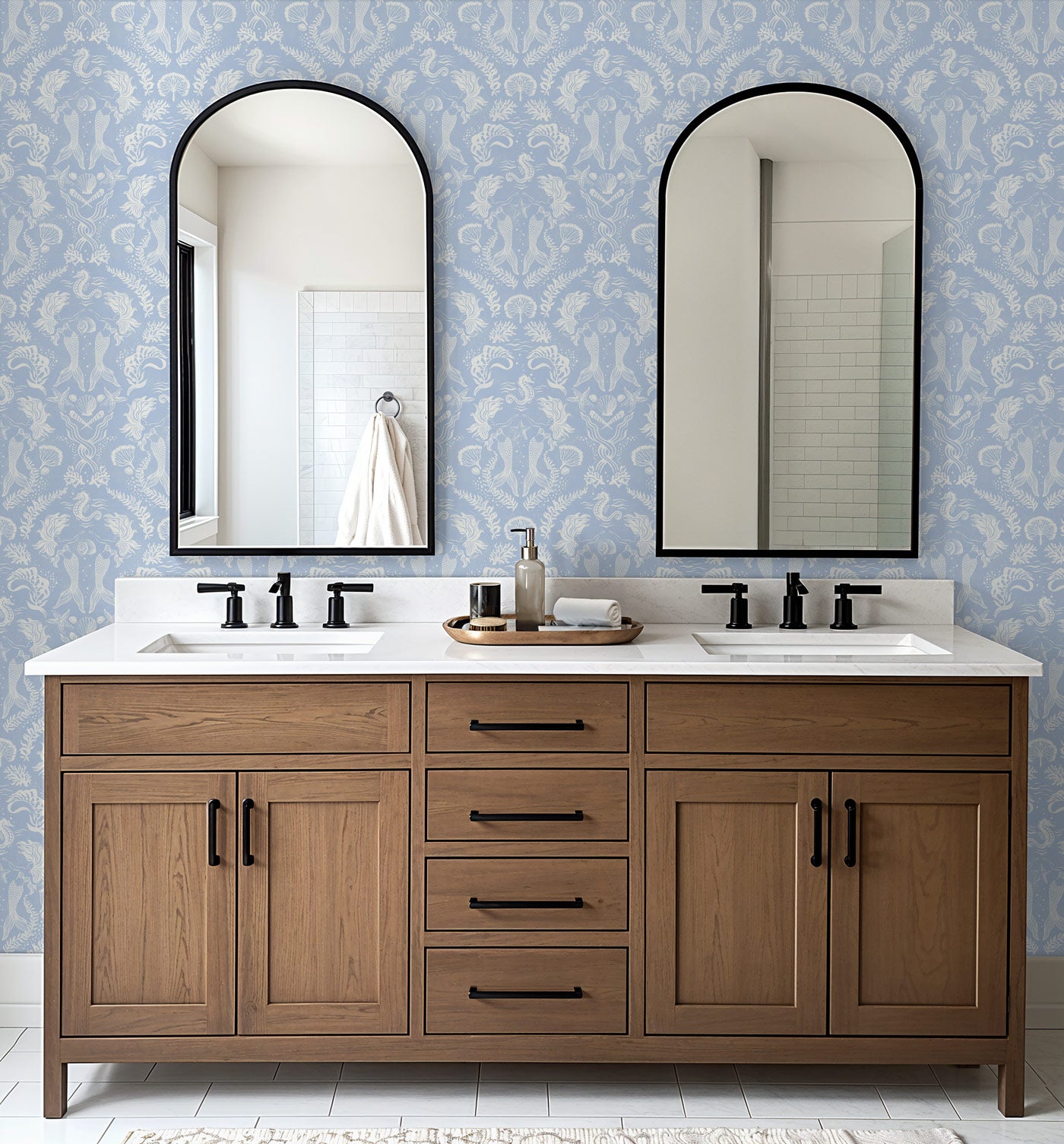 A stunning coastal blue wallpaper with a Dreamy Mermaid motif in a modern double vanity bathroom