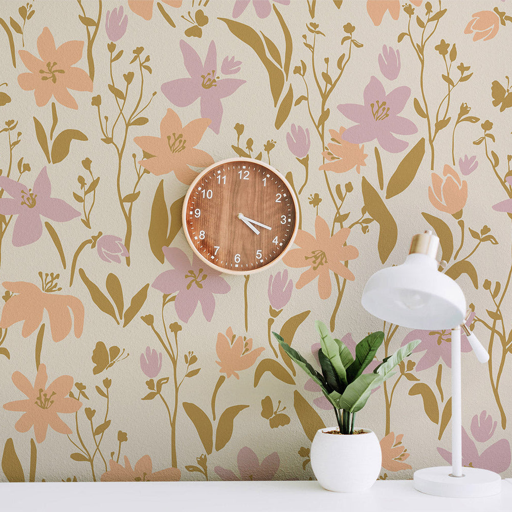 Floral wallpaper with a wooden clock and white lamp on a table.